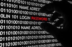 Secure Website from Hackers image of hacker's hand stealing a password from a computer